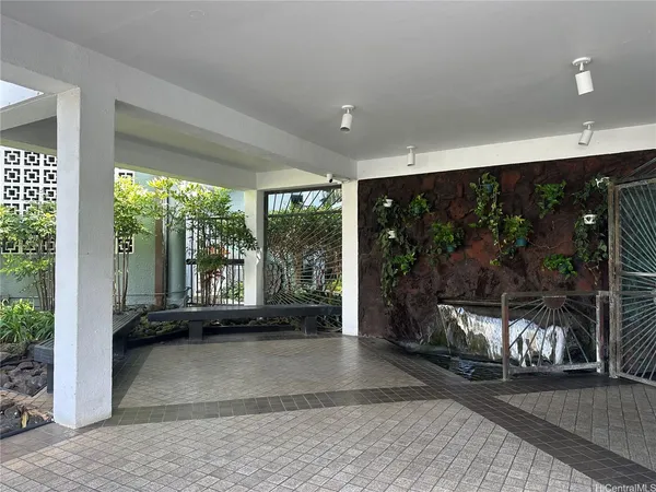 a living room with hardwood floor and ceiling fan
