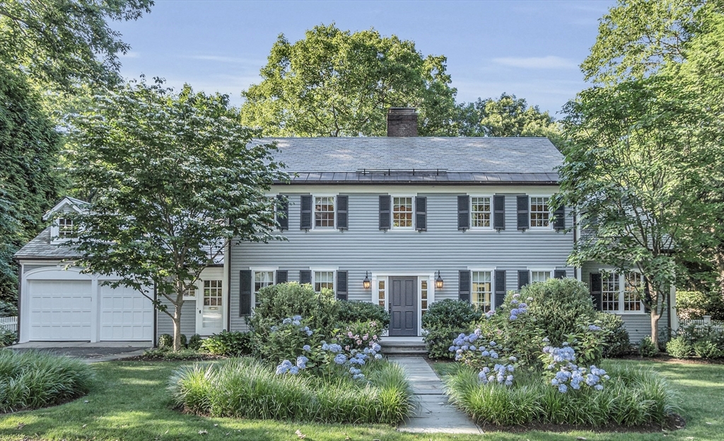 a front view of a house with a garden