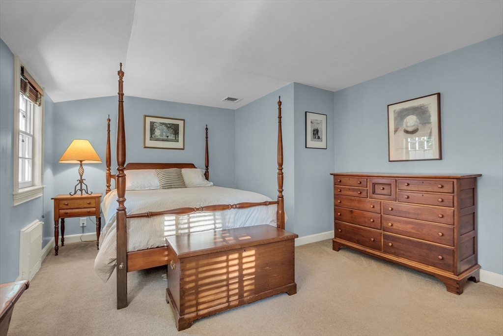 15 Rockridge Road Wellesley, MA 02481 - Photo 25 of 36 a bedroom with a bed and a chandelier