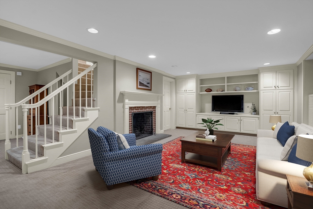 15 Rockridge Road Wellesley, MA 02481 - Photo 33 of 36 a living room with furniture a flat screen tv and a fireplace