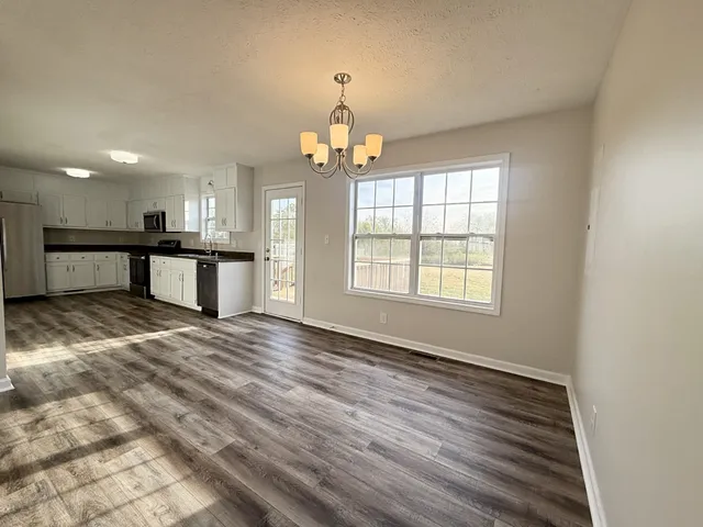 a view of a kitchen with a sink and a window