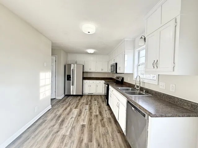 a large kitchen with a lot of counter space and stainless steel appliances