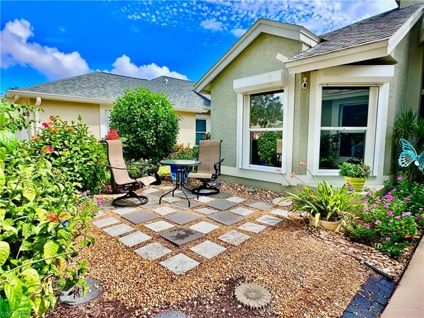 a view of a house with sitting area and garden