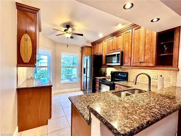 a kitchen with sink a window and dining table
