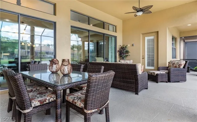 a dining room with furniture and large windows