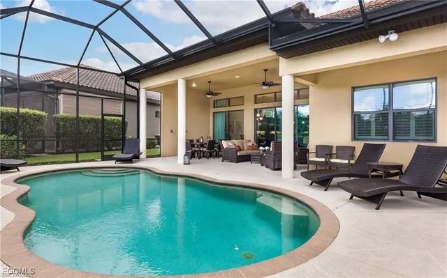 a view of a swimming pool with outdoor seating