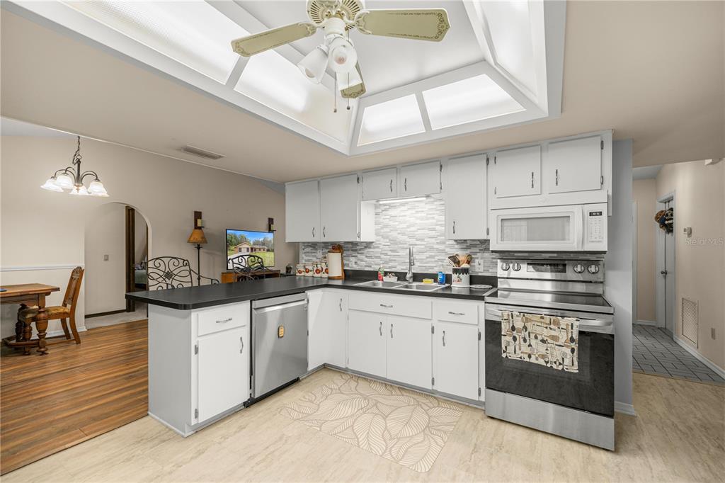 761 South Jeanne Avenue Inverness, FL 34453 - Photo 11 of 33 a kitchen with stainless steel appliances granite countertop a sink and cabinets