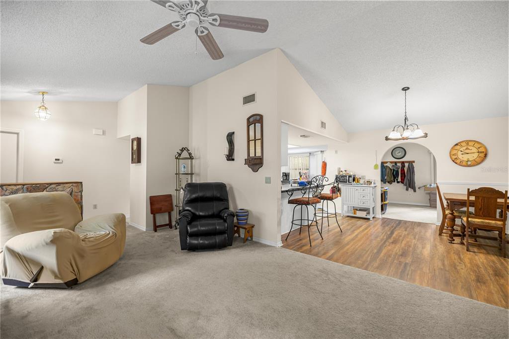 761 South Jeanne Avenue Inverness, FL 34453 - Photo 3 of 33 a living room with furniture and a chandelier