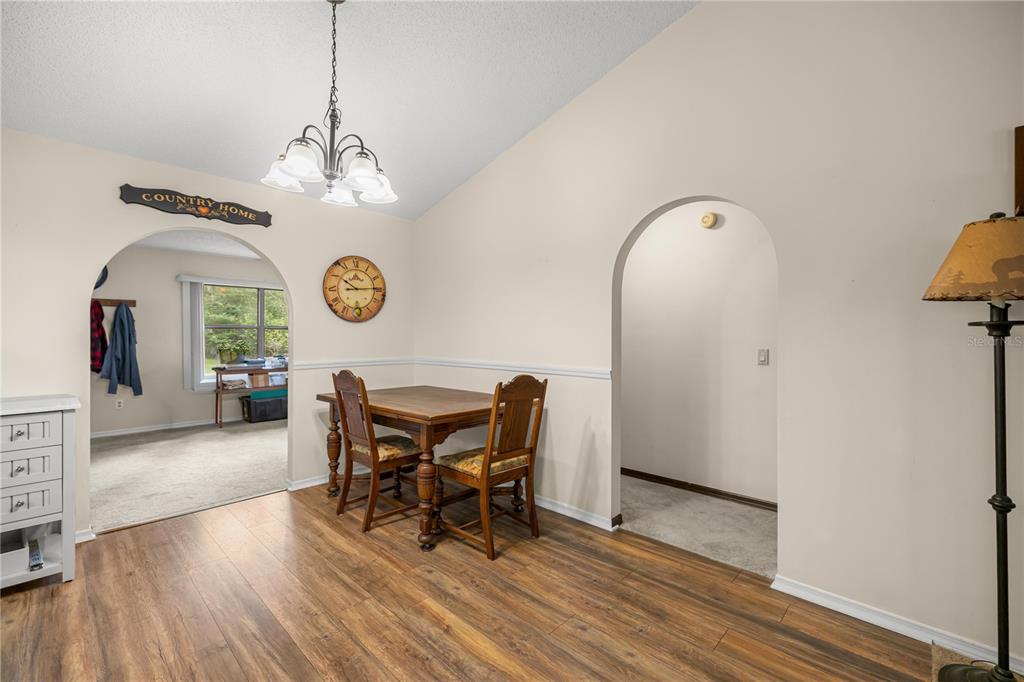 761 South Jeanne Avenue Inverness, FL 34453 - Photo 8 of 33 a view of a dining room with furniture and wooden floor