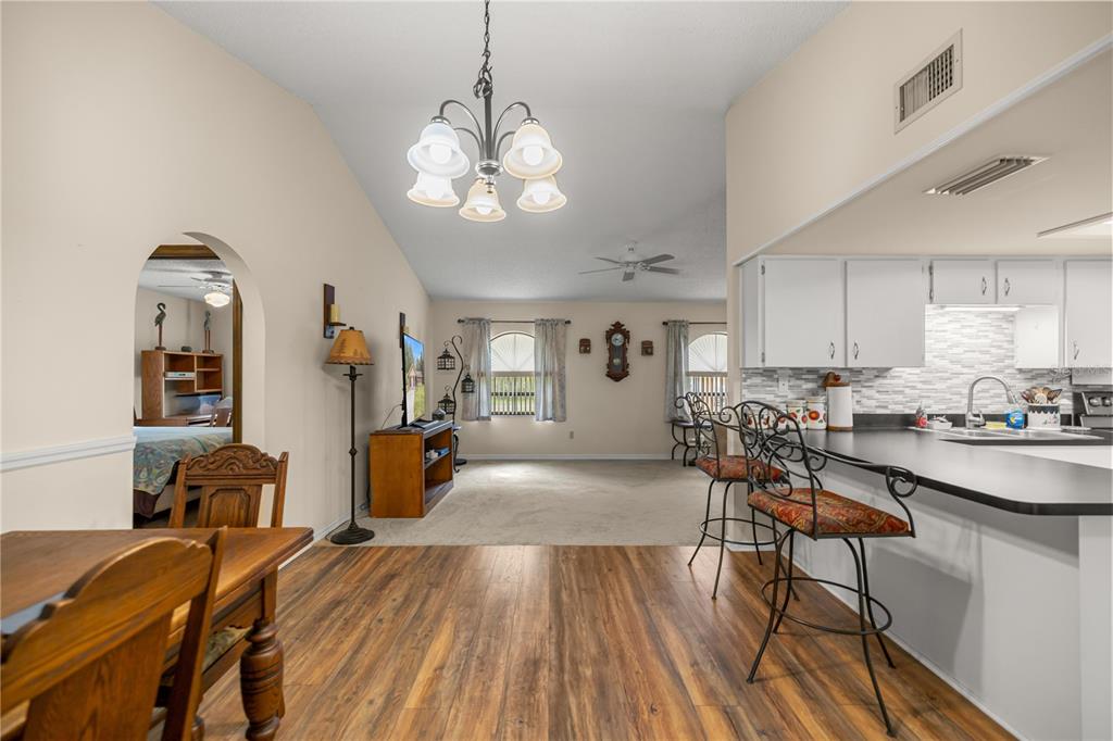 761 South Jeanne Avenue Inverness, FL 34453 - Photo 9 of 33 a view of a dining room with furniture and wooden floor