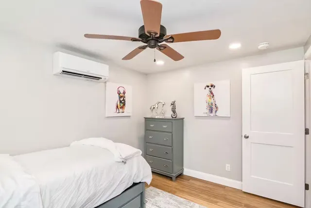 a bedroom with a bed and a chandelier