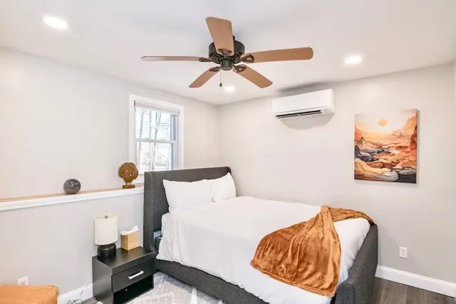 a bedroom with a bed and a painting on the wall