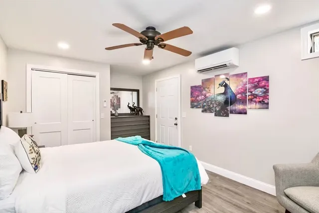 a bedroom with a large bed and a chandelier