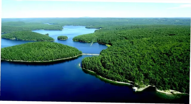 an aerial view of a house with yard and outdoor seating