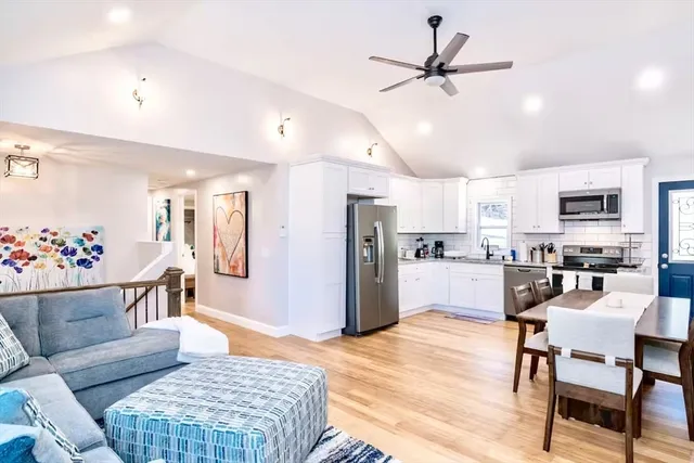 a living room with furniture kitchen view and a dining table
