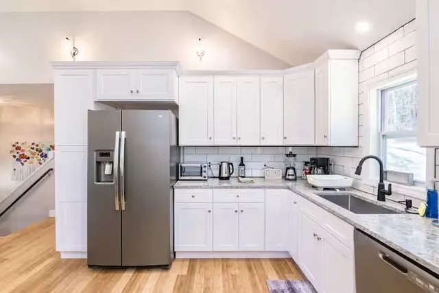 a kitchen with a sink cabinets and stainless steel appliances