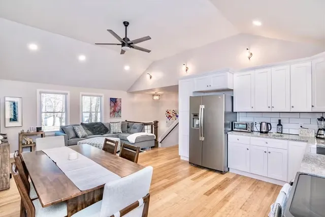 a living room with stainless steel appliances kitchen island granite countertop furniture and a view of kitchen