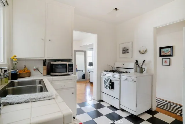 a living room with furniture a large window and a flat screen tv