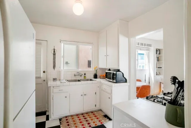 a living room with furniture a fireplace and a large window