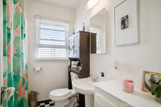 a kitchen with stainless steel appliances a refrigerator a sink and white cabinets