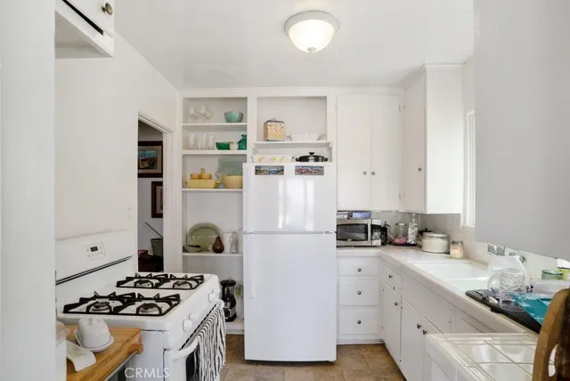 a living room with furniture a flat screen tv and a large window