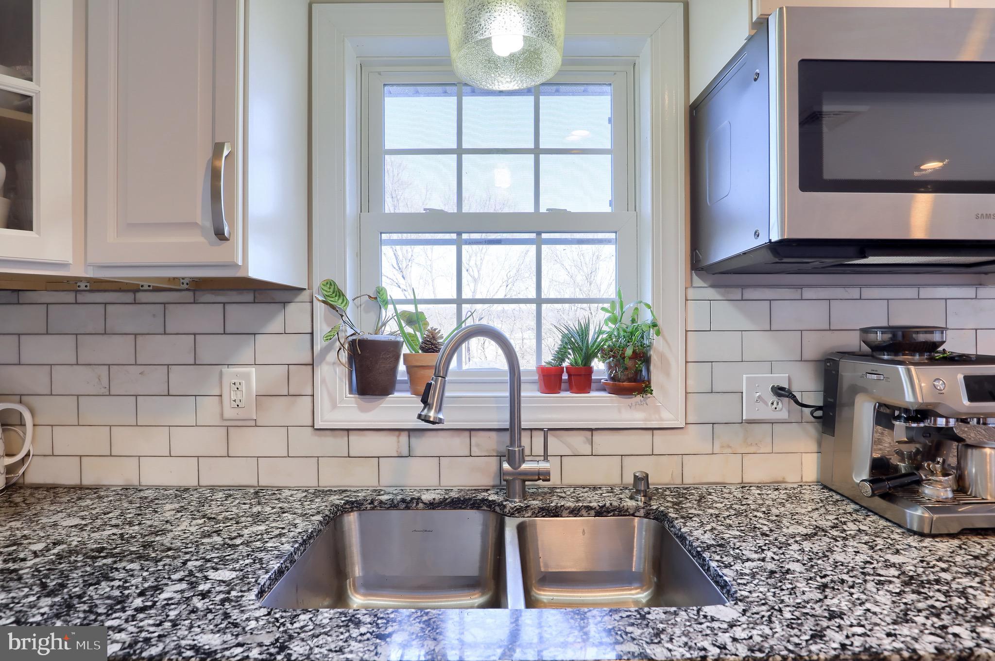 540 Blue Lake Road Denver, PA 17517 - Photo 45 of 63 a kitchen with a granite countertop sink a stove and a window