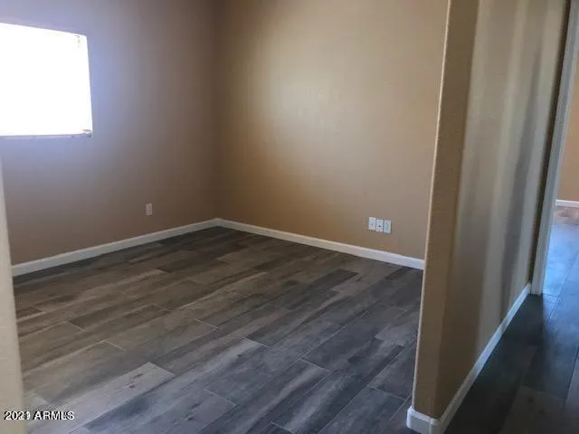 a view of a small space with wooden floor and a window