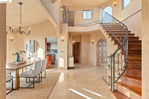 a view of a livingroom with furniture and staircase