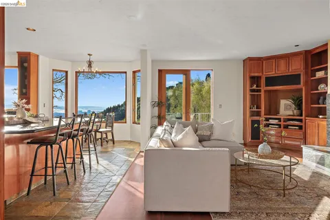 a living room with furniture and large windows