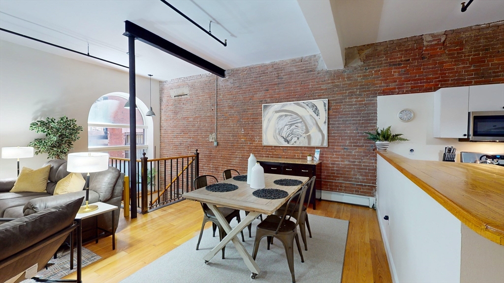19 Stanhope Street, Unit 1D Boston, MA 02116 - Photo 12 of 30 a view of a dining room with furniture and wooden floor