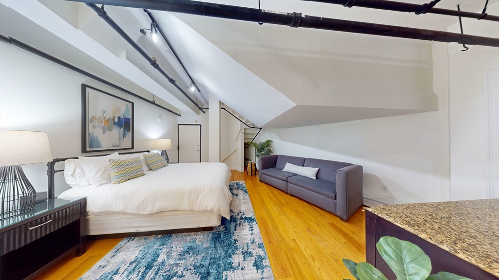 19 Stanhope Street, Unit 1D Boston, MA 02116 - Photo 15 of 30 a bedroom with a bed and wooden floor