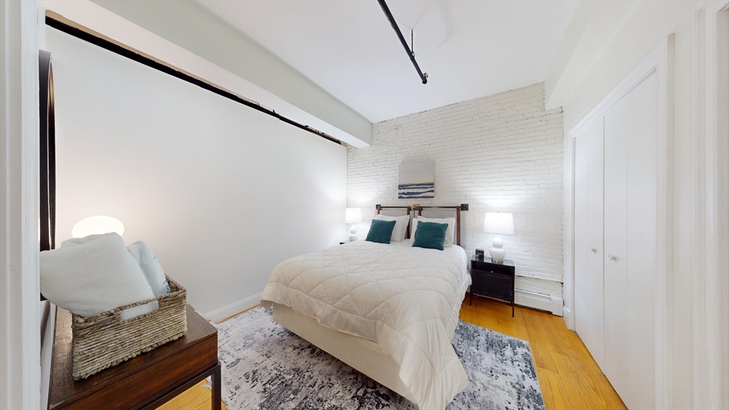 19 Stanhope Street, Unit 1D Boston, MA 02116 - Photo 23 of 30 a bedroom with a bed and dresser