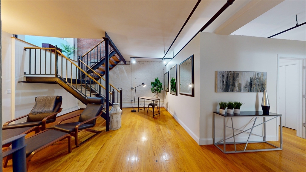 19 Stanhope Street, Unit 1D Boston, MA 02116 - Photo 25 of 30 a view of a livingroom with furniture and hardwood floor