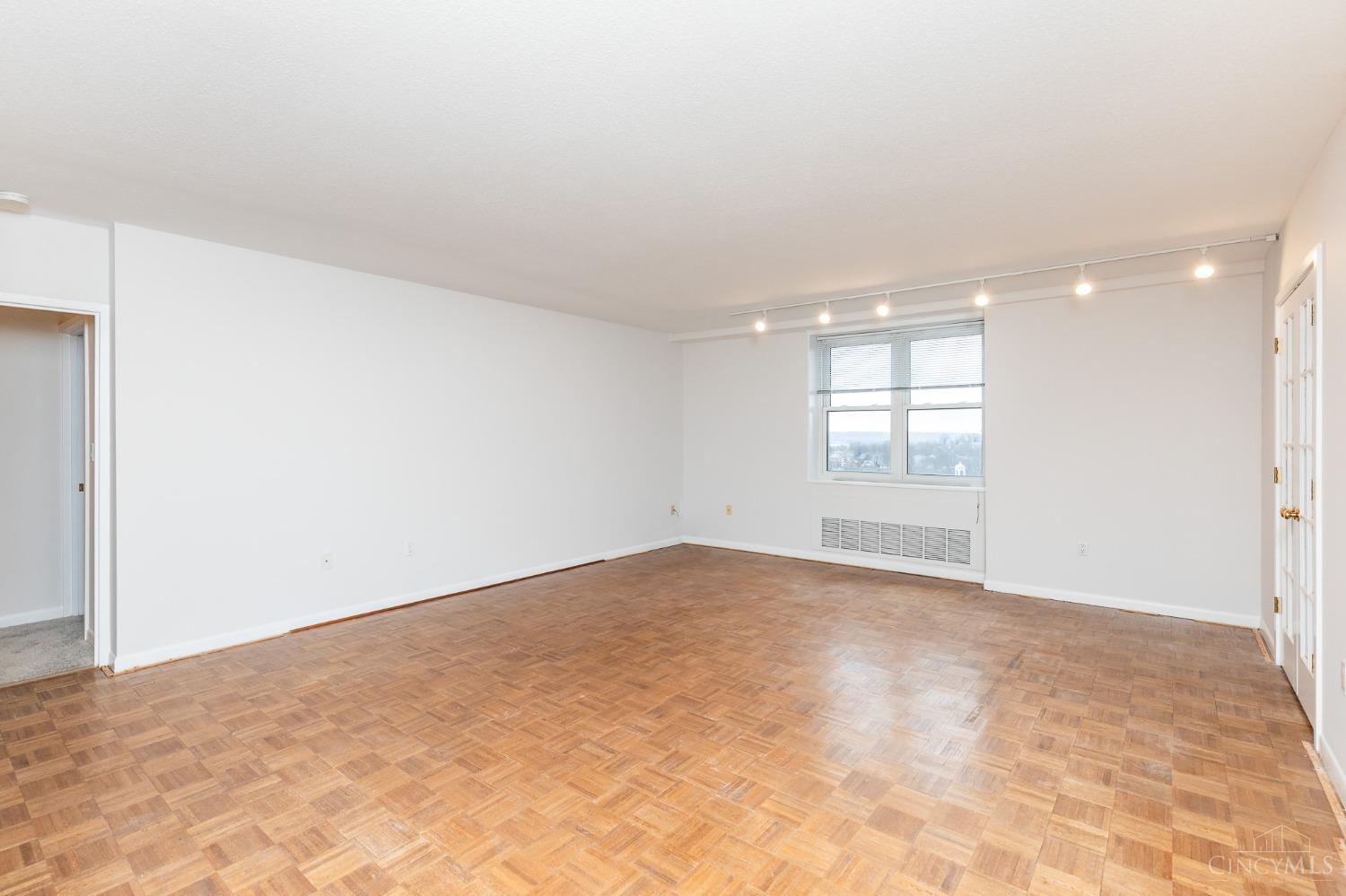 2444 Madison Road, Unit 811 Cincinnati, OH 45208 - Photo 3 of 33 Room unstaged. Pretty views from 8th floor. Nice wood parquet flooring.