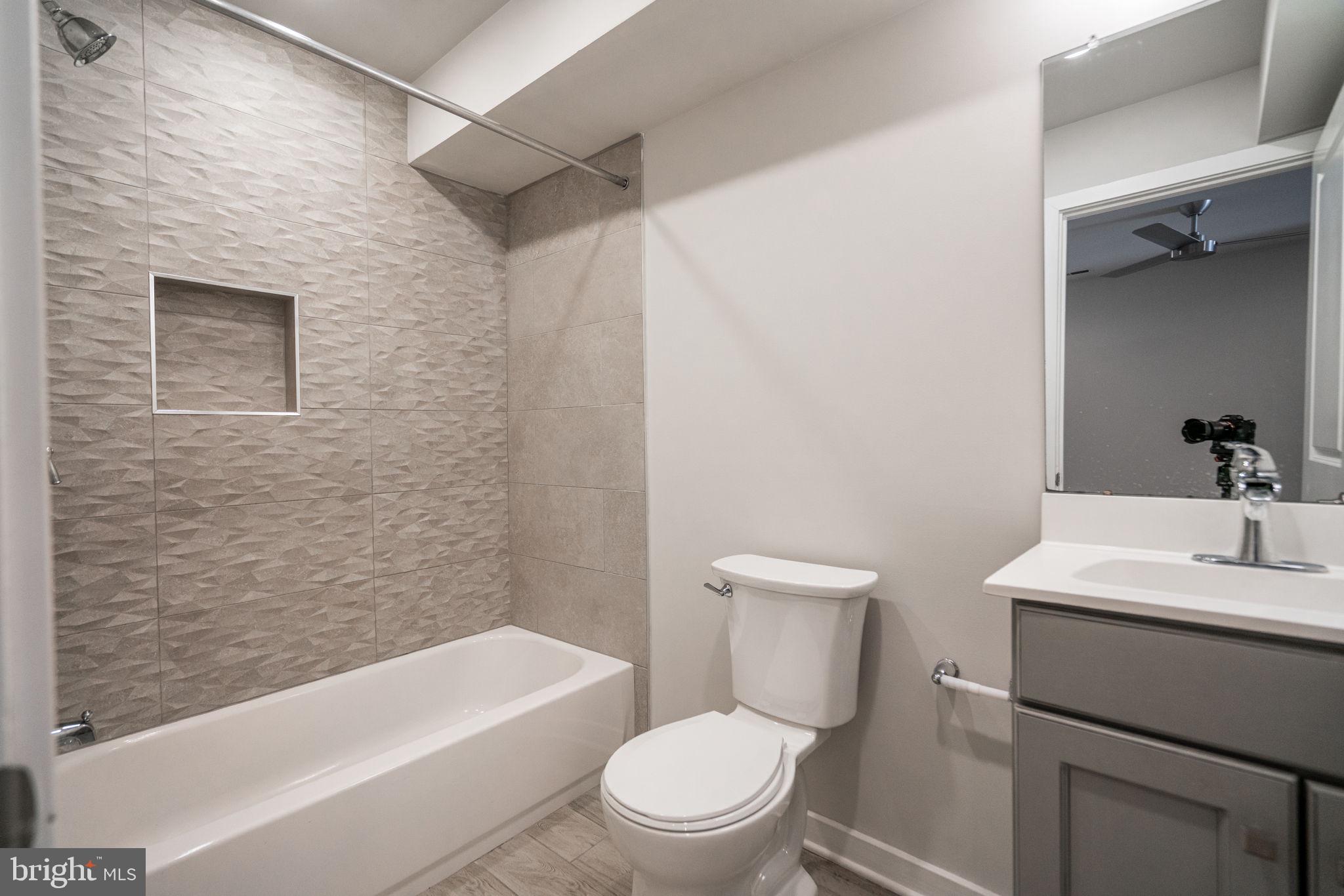 2609 Federal Street, Unit D Philadelphia, PA 19146 - Photo 17 of 27 a bathroom with a toilet a sink and bathtub