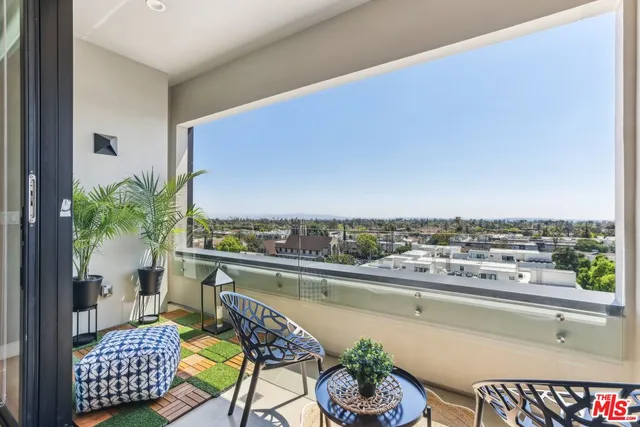 a balcony with furniture and a potted plant