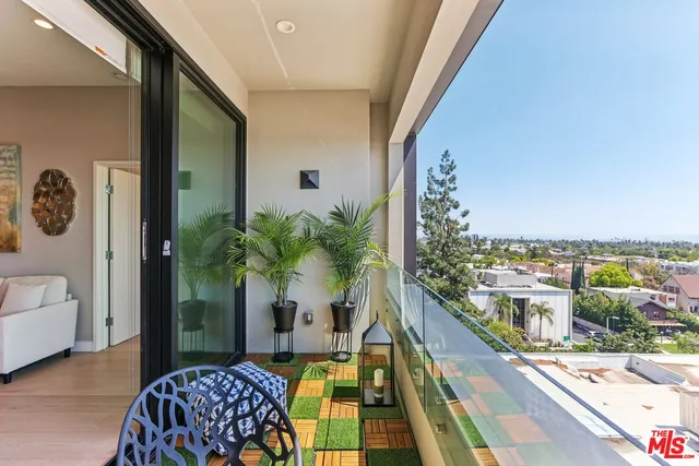 a kitchen with stainless steel appliances granite countertop a stove a sink dishwasher and a dining table with garden view