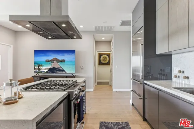 a kitchen with a refrigerator and a stove top oven