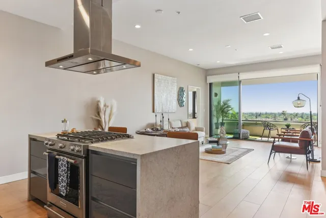 a kitchen with stainless steel appliances granite countertop a stove and refrigerator