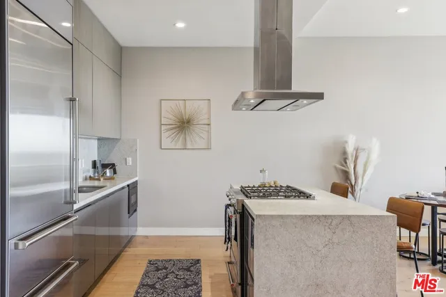 a view of washer and dryer with kitchen in the background