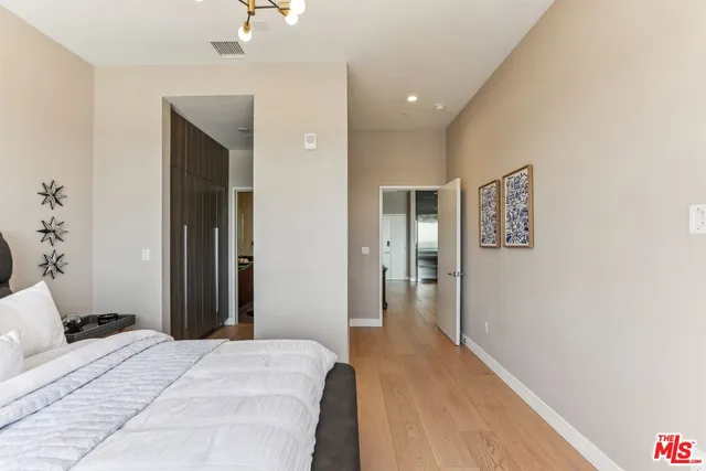 a bathroom with a granite countertop sink a mirror and shower