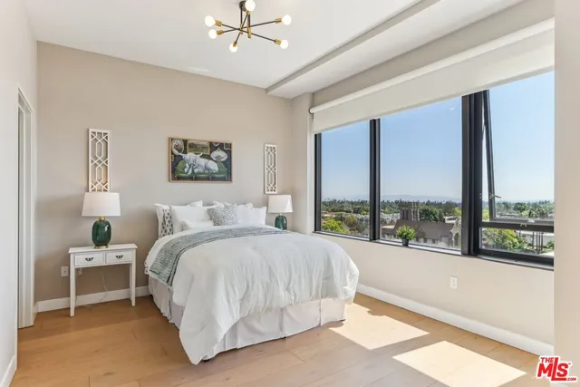 a bedroom with a bed potted plant and a window