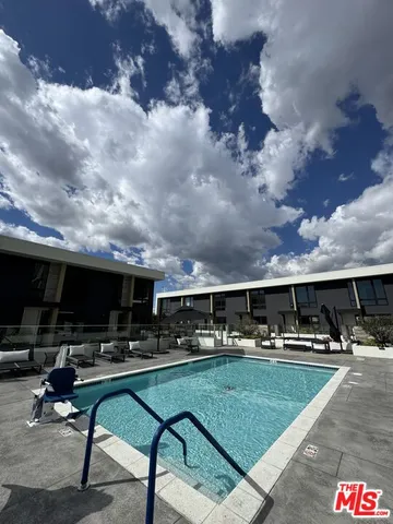 a building outdoor space with patio furniture and potted plants