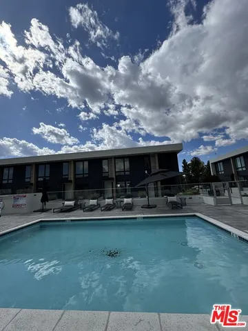 a living room with lots of furniture and kitchen view