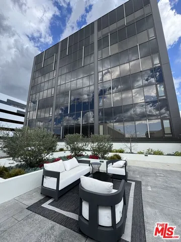 a view of a balcony with a floor to ceiling window