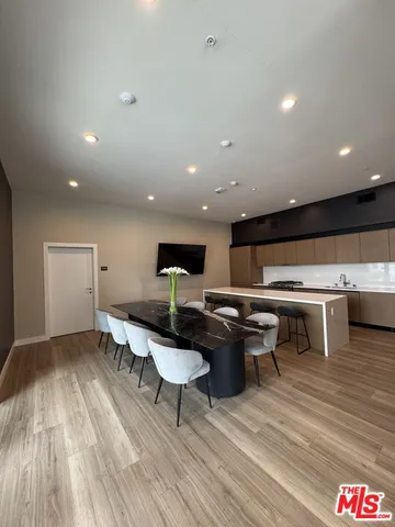 a view of a brick building with plants next to a road