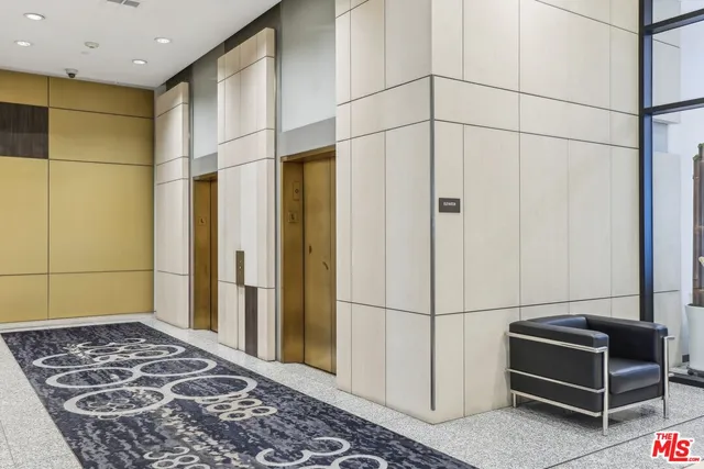 a living room with fireplace furniture and a large window