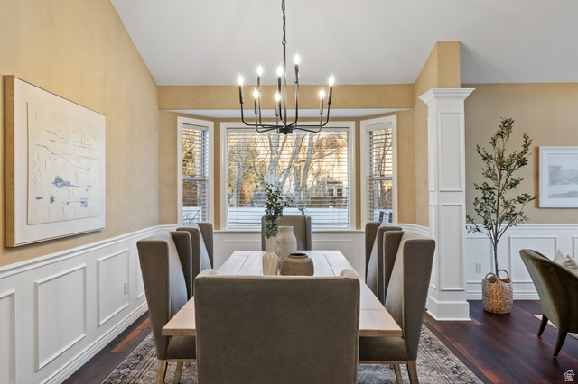6208 West Bull River Road Highland, UT 84003 - Photo 8 of 90 Dining area featuring a bay window, wood-finish flooring, wainscoting, and a candelabra-style chandelier