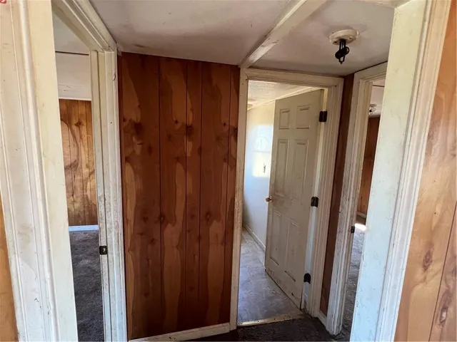 a view of a hallway with wooden door