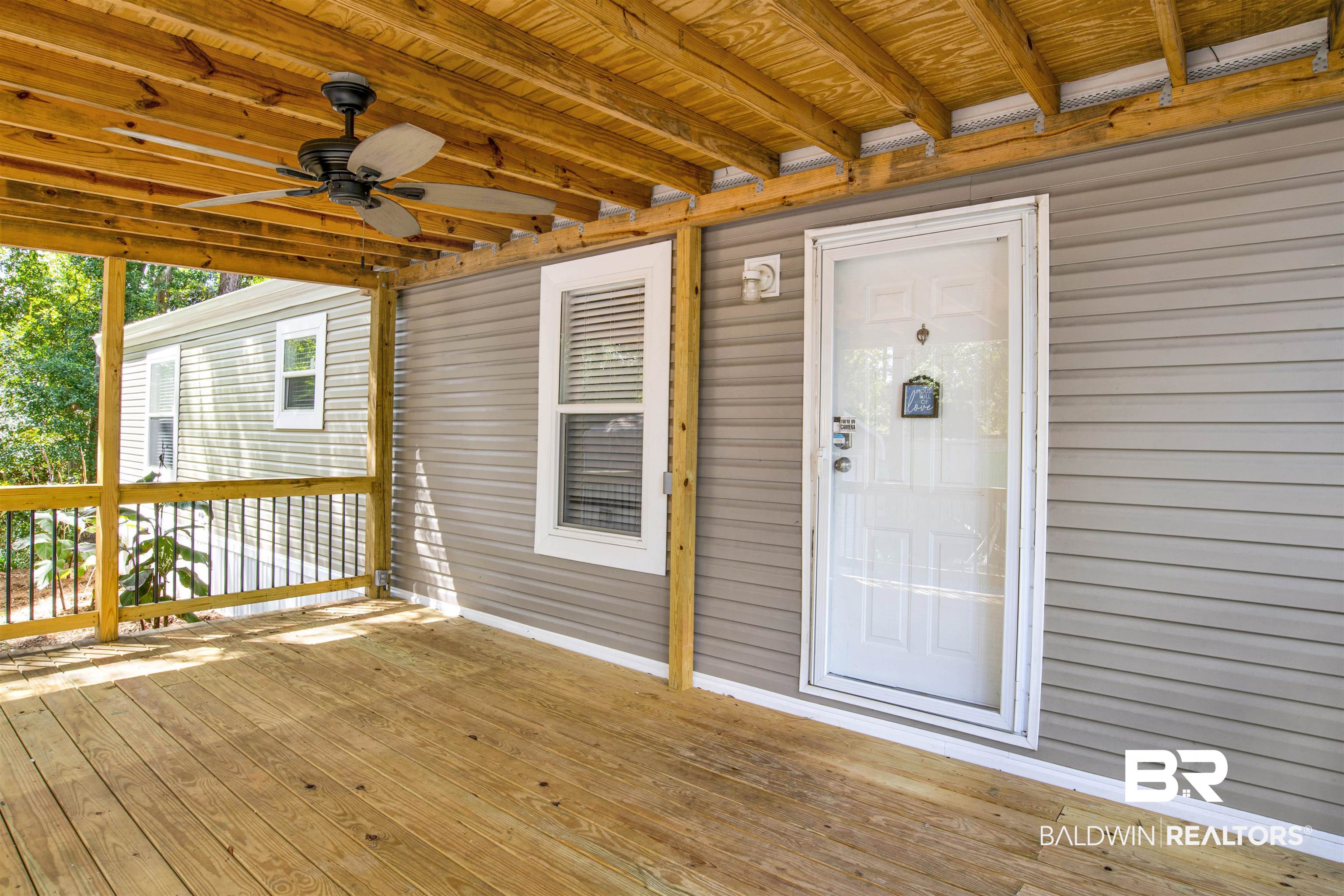 1411 Ridgewood Drive Lillian, AL 36549 - Photo 7 of 30 Wooden terrace with ceiling fan